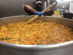 Food For All charity cooking a huge pan of kitchari